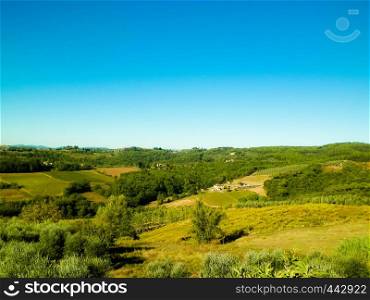 Hills, fields and meadows - typical views of Tuscany, Italy. Travel, nature and agriculture concept. Sunny autumn day, vacations in Italy. Copy space.. Hills, fields and meadows - typical views of Tuscany, Italy.