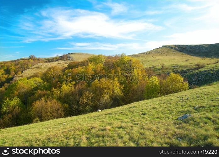 Hills with cloudscape and blue sky. Landscape.