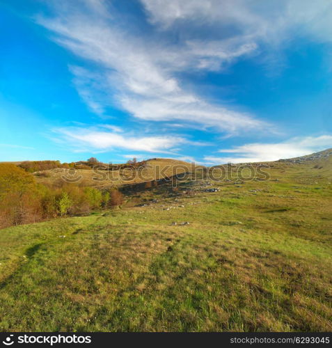 Hills with cloudscape and blue sky. Landscape.