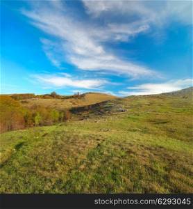 Hills with cloudscape and blue sky. Landscape.
