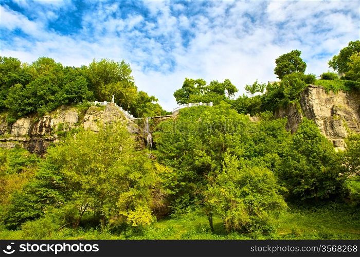 hillside with bushes at sunny summer day