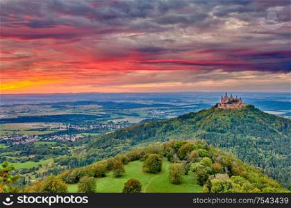 Hilltop Hohenzollern Castle on mountain top at sunset in Swabian Alps, Baden-Wurttemberg, Germany