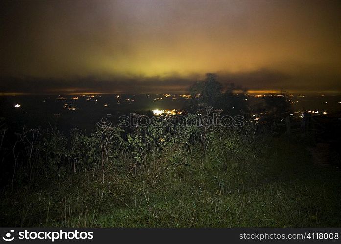 Hilltop view overlooking city at night