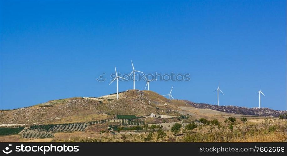 hilly landscape where there is a wind power plant