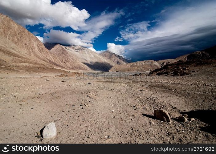 Himalaya high mountain landscape. Desert under dramatic cloudy sky. India, Ladakh, altitude 4600 m