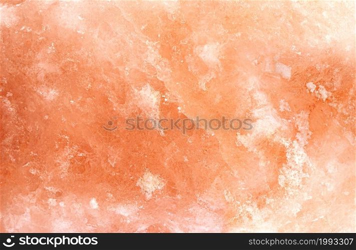 Himalayan block salt surface. Natural huge crystal Pakistani pink orange salt background, top view
