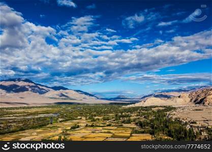 Himalayan landscape of historic Indus valley surrounded by Karakoram range of Himalaya mountains. View from Buddhist temple Thiksey gompa. Ancient civilization of Bronze Age South Asia. Ladakh, India. Himalayan landscape of Indus valley surrounded by Karakoram range Himalaya mountains. Ladakh, India