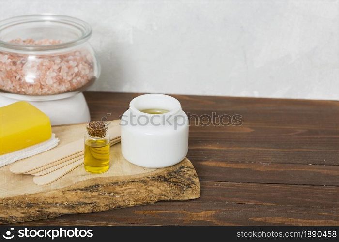 himalayan rock salt glass jar wax wooden sticks honey herbal yellow soap essential oil bottle table