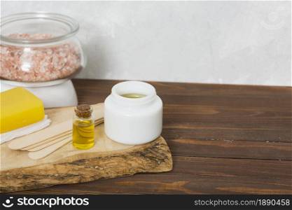 himalayan rock salt glass jar wax wooden sticks honey herbal yellow soap essential oil bottle table