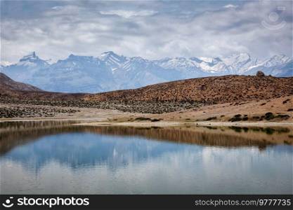 Himalayas mountains refelcting in mountain lake Dhankar Lake. Spiti Valley, Himachal Pradesh, India. Dhankar Lake. Spiti Valley, Himachal Pradesh, India