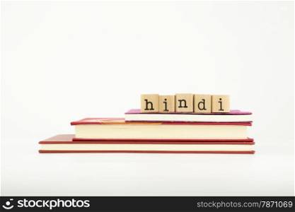 hindi word on wood stamps stack on books, language and study concept