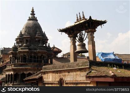 Hindu temple and bronze bell on the Durbar square in Patan, Nepal