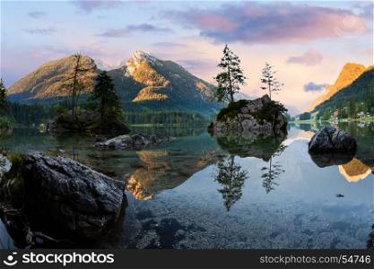 Hintersee alpine mountain lake and clousy colorful sunrise