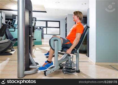 Hip abduction blond man exercise at gym indoor opening legs workout
