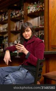 Hip Caucasian Woman Sitting At A Bar And Looking Bored