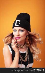 Hip-hop woman in cap with long hair. Fashion portrait of modern girl in cap.