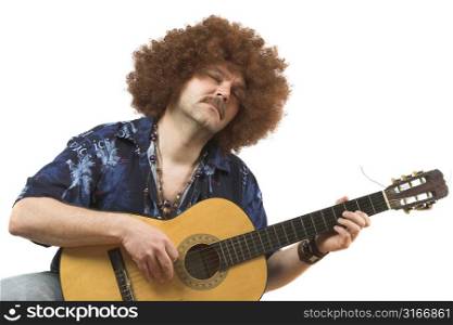 Hippy with old guitar totally into his music