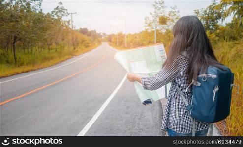 Hipster Asian woman backpacker . Hipster Asian woman backpacker look map on trip