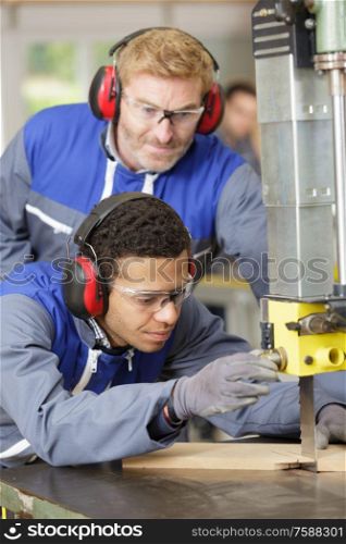 hipster carpenter working with table saw in workshop