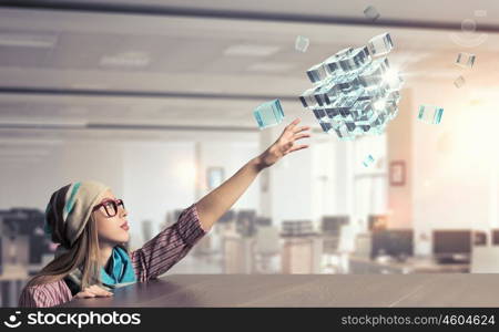 Hipster girl looking from under table. Attractive student girl in red glasses peeping from under table