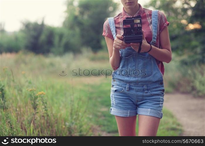 Hipster girl posing with instant camera