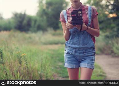 Hipster girl posing with instant camera