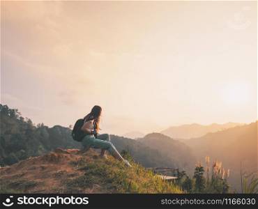 hipster girl with backpack enjoying sunset on hill. solo traveling, happiness emotion, summer holiday concept