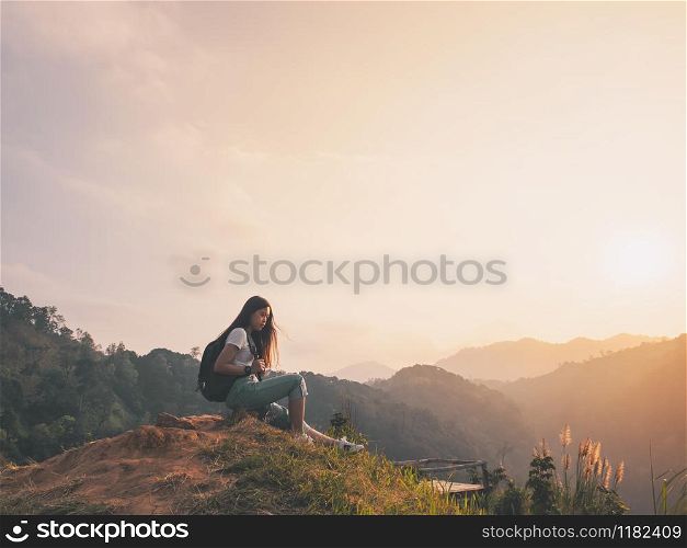 hipster girl with backpack enjoying sunset on hill. solo traveling, happiness emotion, summer holiday concept