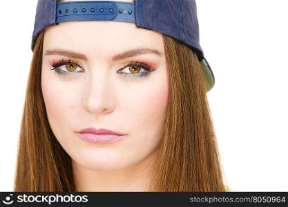 Hipster girl with cap. . Clothing people concept. Hipster girl with cap. Good looking young lady with beautiful colourful make up.