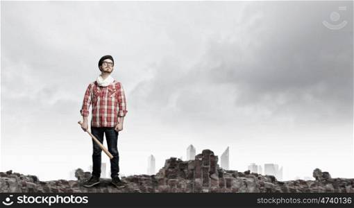 Hipster guy with bat. Furious hipster guy breaking wall with baseball bat