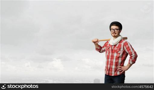 Hipster guy with bat. Hipster guy in checked shirt and hat with baseball bat