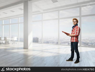 Hipster guy with book. Hipster guy with book in hands in modern interior. Mixed media