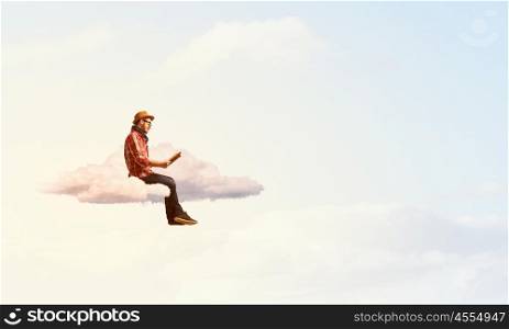 Hipster guy with book. Hipster guy with book in hands on cloud in sky