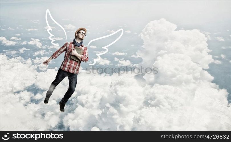 Hipster guy with book. Hipster guy with book in hands on cloud in sky