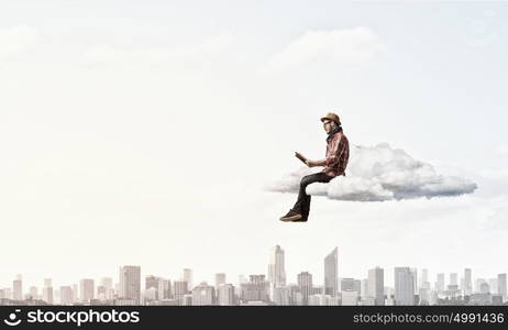 Hipster guy with book. Hipster guy with book in hands on cloud in sky