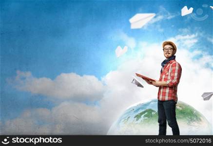 Hipster guy with book in hands. Hipster guy with book in hands in empty room. Elements of this image are furnished by NASA