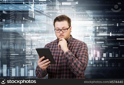 Hipster guy with tablet device. Young thoughtful man in checked shirt using tablet pc