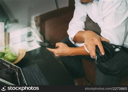hipster hand holding headphone,using digital tablet docking keyboard and mobile payments online business,omni channel,sitting on sofa in living room,green apples in wooden tray,filter effect