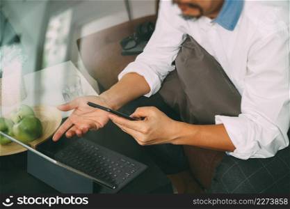 hipster hand using digital tablet docking keyboard and mobile payments online business,omni channel,sitting on sofa in living room,green apples in wooden tray,filter effect