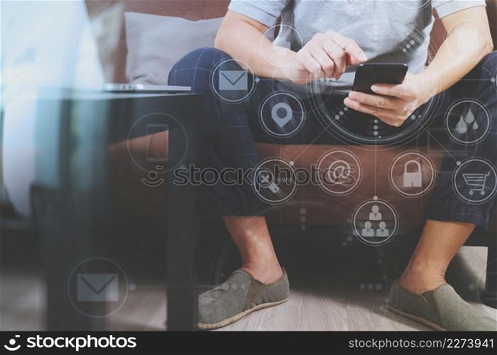 hipster hand using digital tablet docking keyboard and smart phone for mobile payments online business,omni channel,sitting on sofa in living room,green apples in wooden tray,virtual computer interface omni channel