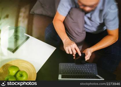 hipster hand using digital tablet docking keyboard and smart phone for mobile payments online business,omni channel,sitting on sofa in living room,green apples in wooden tray,filter effect