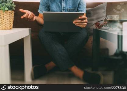 hipster hand using digital tablet docking keyboard,holding cradit card payments online business,sitting on sofa in living room,work at home concept,filter effect