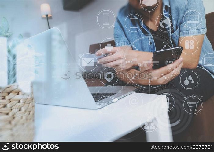 hipster hand using smart phone and laptop compter,holding cradit card payments online business,sitting on sofa in living room,green apples in wooden tray,graphic interfce icons virtual screen