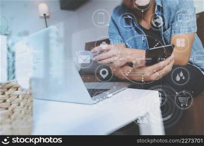 hipster hand using smart phone and laptop compter,holding cradit card payments online business,sitting on sofa in living room,green apples in wooden tray,graphic interfce icons virtual screen