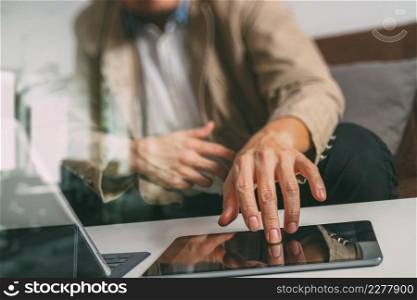 hipster hand using smart phone,digital tablet docking keyboard,coffee cup, payments online business,sitting on sofa in living room,work at home concept