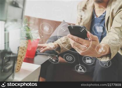 hipster hand using smart phone,digital tablet docking keyboard,coffee cup, payments online business,sitting on sofa in living room,work at home concept,virtual interface graphic icons diagram