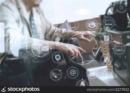 hipster hand using smart phone,digital tablet docking keyboard,coffee cup, payments online business,sitting on sofa in living room,work at home concept,virtual interface graphic icons diagram