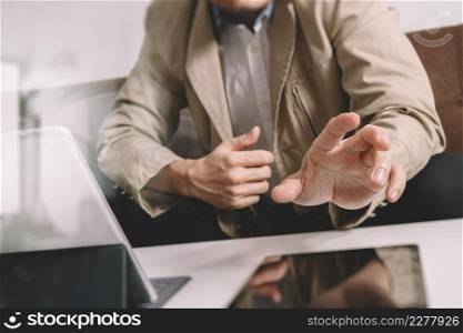 hipster hand using smart phone,digital tablet docking keyboard,coffee cup, payments online business,sitting on sofa in living room,work at home concept,filter effect