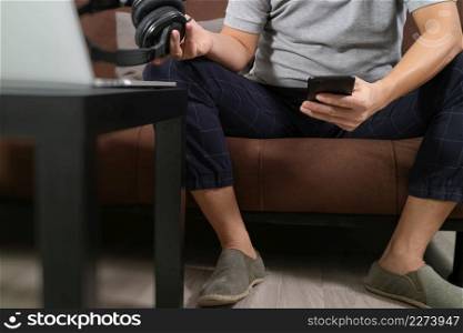 hipster hand using smart phone for mobile payments online business,headphone,sitting on sofa in living room