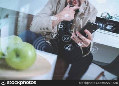 hipster hand using smart phone for mobile payments online business,sitting on sofa in living room,holding green apple in wooden tray,virtual computer interface omni channel